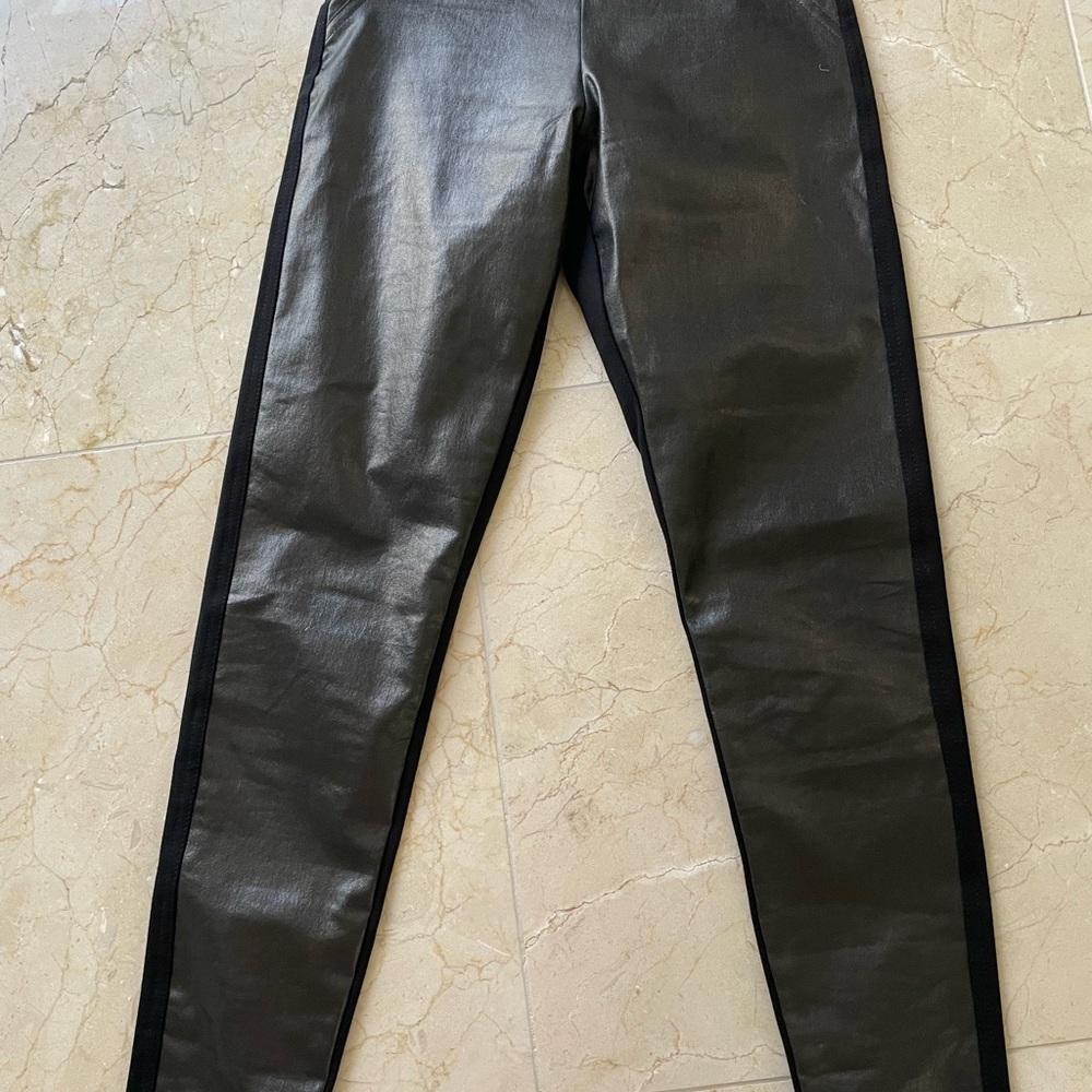 Faux leather pants with stretch knit back.